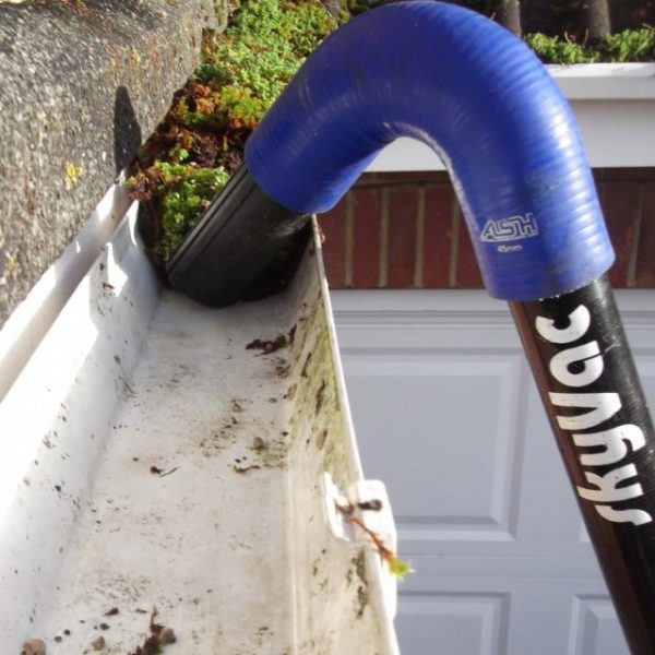 SkyVac ladderless gutter system in use